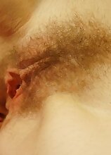 Sleepy mature amateur Dorena wakes up and fingers her hairy pussy.