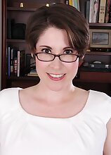 Busty mature babe Sadie Jones naked on her desk.