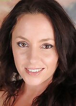 Curvy brunette MILF Tamara Fox bends over and touches her toes.