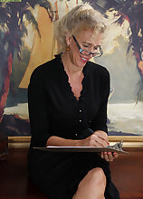 Blond cougar Cally Jo spreads her hairy pussy on the desk.