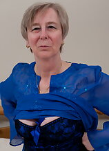 Naughty mom playing alone on her bed