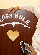 Mature nanny sucking a black cock through a gloryhole