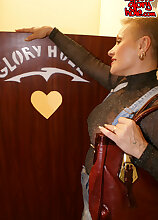 Kinky mature slut sucking through the gloryhole