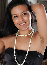 Elegant and mature Julie Ann puts on a strip show before spreading