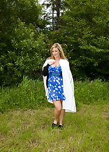 Watch busty MILF Janny Badeau strip and spread in the farmers field
