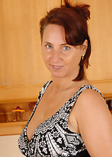 Sexy MILF Demi undresses and spreads her 45 year old legs here