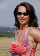 Natural titted Demi from AllOver30 plays nudist out in the farmers field
