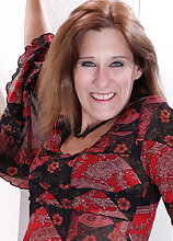 Elegant MILF Jay Dee undresses and spreads her mature pussy here