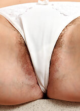 Long haired mature brunette lets her pussy hairy peek from her panties