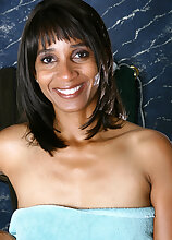 Ebony MILF Sara rubs cream all over her shaven mature pussy
