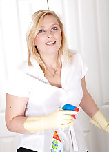 Feature mature model Tamara strips after dusting the table