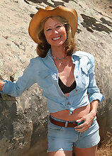 61 year old Janet L peels of her blue jeans and spreads on the rocks