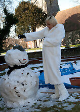 Pregnant and mature Jan warms up after playing outside in the snow
