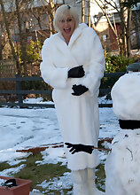 Pregnant and mature Jan warms up after playing outside in the snow
