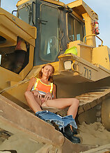 Petite MILF spreads her legs outside with the construction tractors