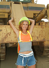Petite MILF spreads her legs outside with the construction tractors