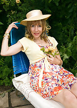 Sexy and petite Lizzy shows off her hairy pussy out in her garden