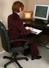 Short haired MILF with a shaved pussy spreads her legs at work