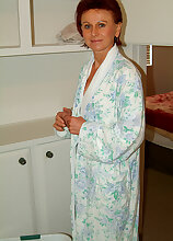 Redheaded MILF with a hairy pussy leaves her bathrobe undone