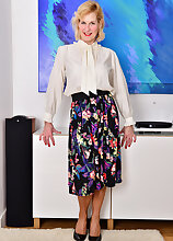 Busty Molly Maracas takes off her long skirt to show her stockings and panties