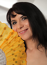 Latina honey Gracia Saluda fans herself and strips down naked to play