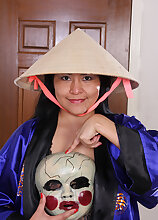Beautiful exotic CiCi Jones takes off her robe and hat to hang out in the nude